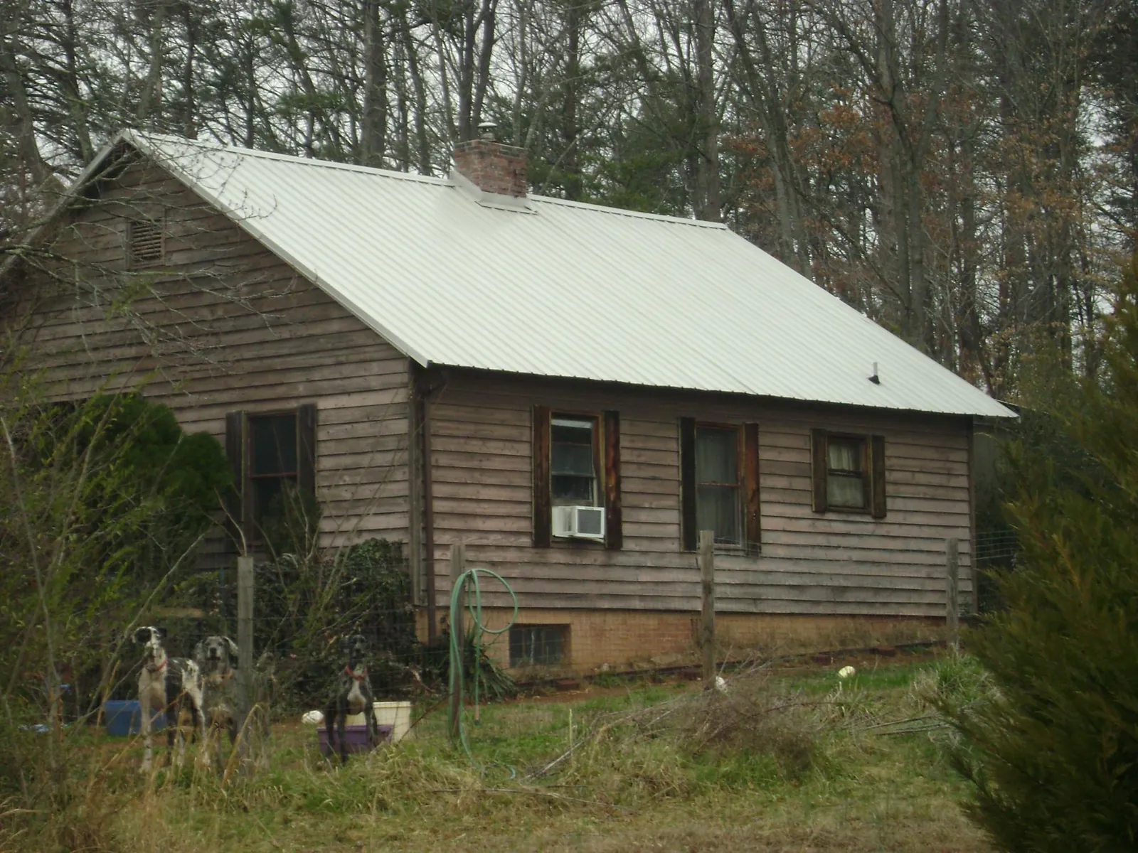 White metal roof on an old wood sided farmhouse, from a Metal Roof Installation job in Adena